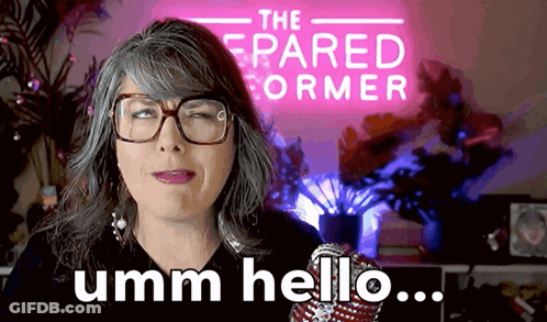 Woman With Glasses Says Umm Hello In Front Of The Pared Former Sign GIF