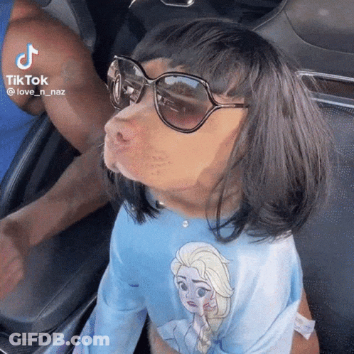 Woman With Glasses Screaming Holding Stuffed Animal In Mouth GIF
