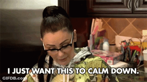 Woman With Glasses Sitting In Kitchen GIF