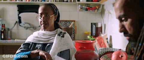 Woman With Glasses Sitting In Kitchen With Man GIF
