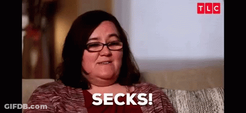 Woman With Glasses Sitting On Couch Says Socks GIF