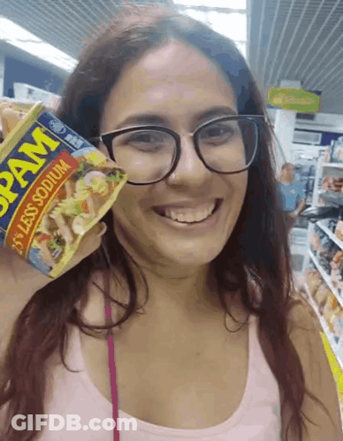 Woman With Glasses Smiling Holding Spam Can GIF