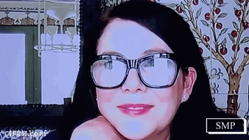 Woman With Glasses Smiling With SMP Sign GIF