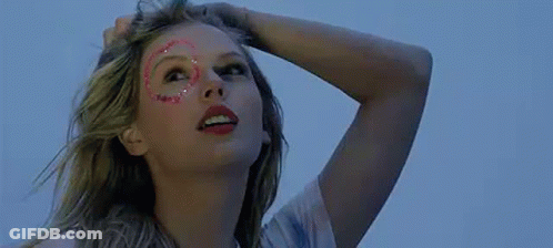 Woman With Glitter On Face Holding Hair Looking Up GIF