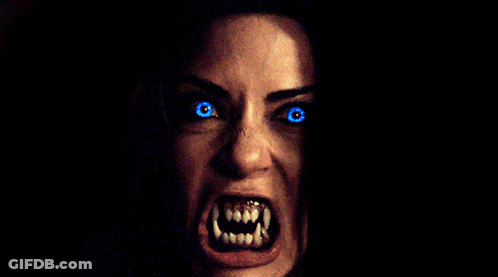 Woman With Glowing Blue Eyes And Teeth GIF