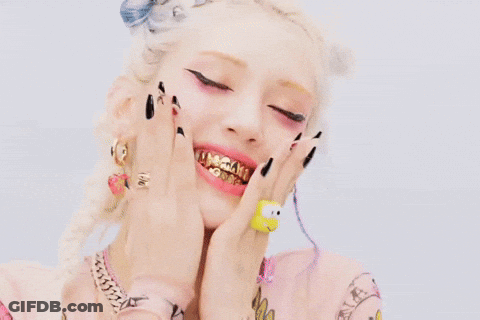Woman With Gold Teeth And Hello Kitty Ring GIF