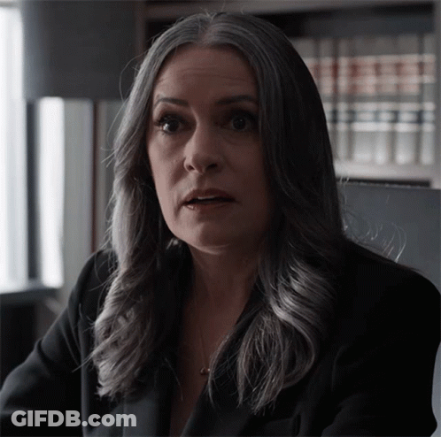 Woman With Gray Hair Looks At Camera GIF