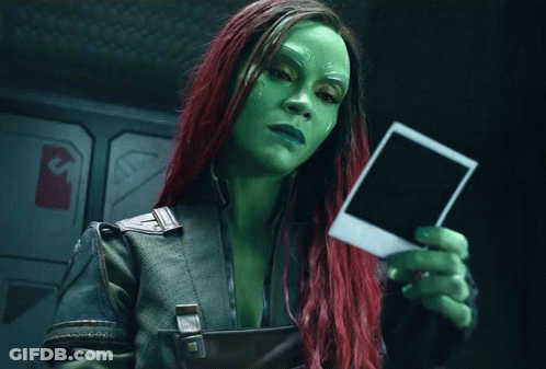 Woman With Green And Red Hair Holding Polaroid GIF
