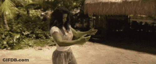 Woman With Green Arms And Legs Standing On Beach GIF
