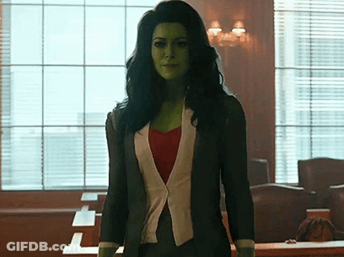 Woman With Green Hair And Green Face Standing In Front Of Window GIF