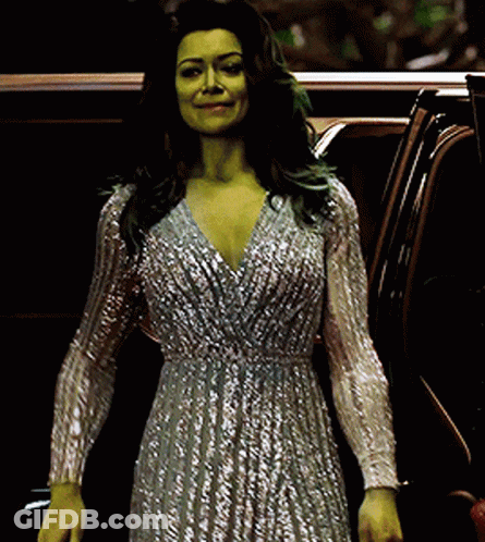 Woman With Green Hair And Silver Dress Standing Next To Car GIF