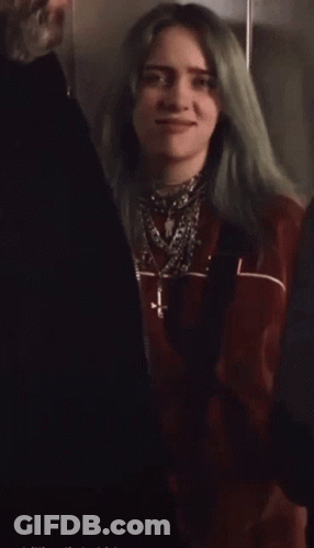 Woman With Green Hair In Red Jacket And Necklaces GIF
