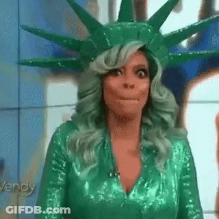 Woman With Green Hair In Statue Of Liberty Costume Making Funny Face GIF