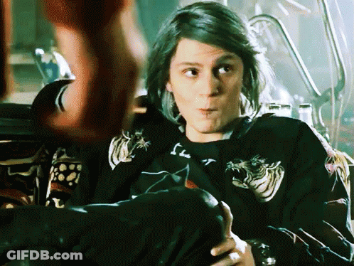 Woman With Green Hair Wearing Black Dragon Shirt GIF