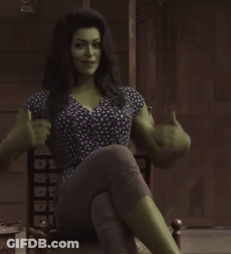 Woman With Green Muscles Sitting Cross-Legged GIF