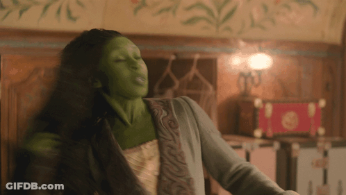 Woman With Green Paint On Face Dancing GIF
