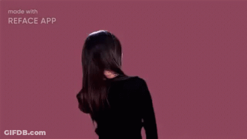 Woman With Hair Blowing In Wind On Pink Background GIF