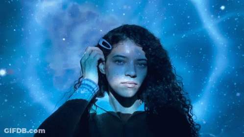 Woman With Hair Clip In Front Of Blue Background GIF