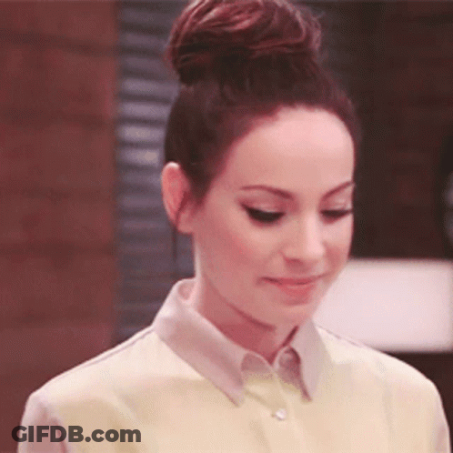 Woman With Hair In Bun Wearing Yellow Shirt GIF