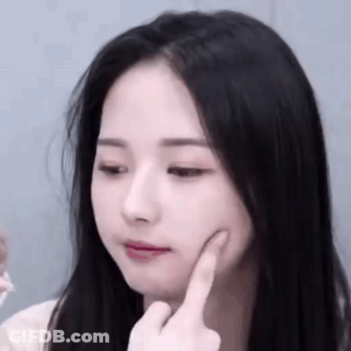 Woman With Hand On Chin Close Up GIF