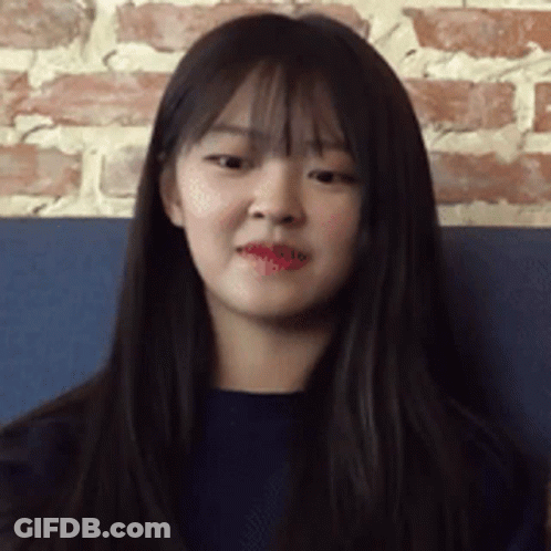 Woman With Hand On Forehead In White Floral Shirt GIF