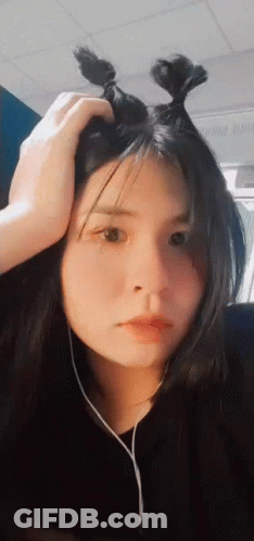 Woman With Hand On Head And Hair Bun GIF