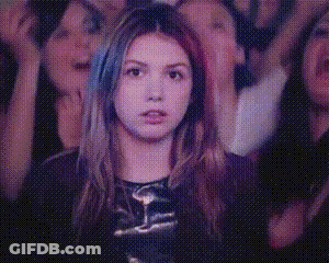 Woman With Hands In Air In Front Of Crowd GIF