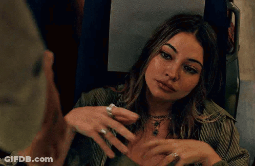Woman With Hands On Chest Looking In Mirror GIF