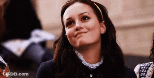 Woman With Headband Smiling Looking Up In Classroom GIF