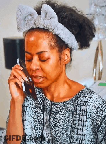 Woman With Headband Talking On Phone GIF