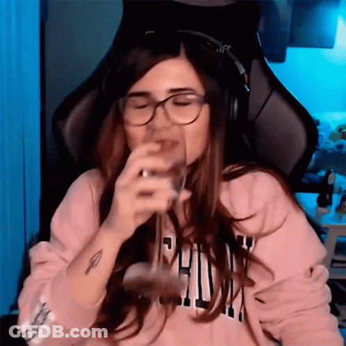Woman With Headphones And Glasses Drinking From Glass GIF