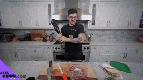 Woman With Headphones Dancing In Kitchen Saying Complete GIF