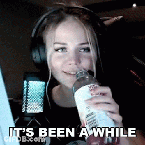 Woman With Headphones Drinking Water Saying It's Been A While GIF