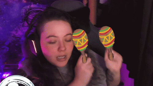 Woman With Headphones Holding Colorful Maracas GIF