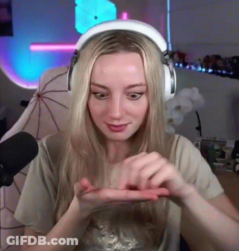 Woman With Headphones Holding Small Object GIF