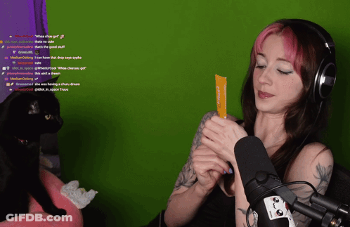 Woman With Headphones Holding What The Girl Card GIF
