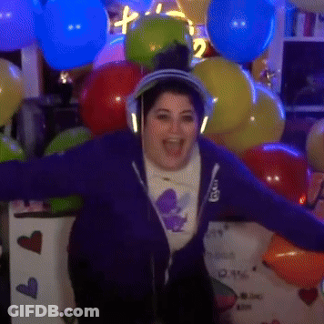 Woman With Headphones In Front Of I Love You Sign And Balloons GIF