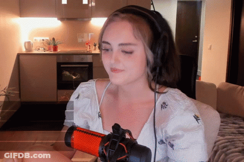 Woman With Headphones In Front Of Red And Black Microphone GIF