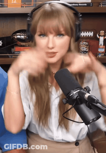 Woman With Headphones In Front Of Taylor Swift Microphone GIF