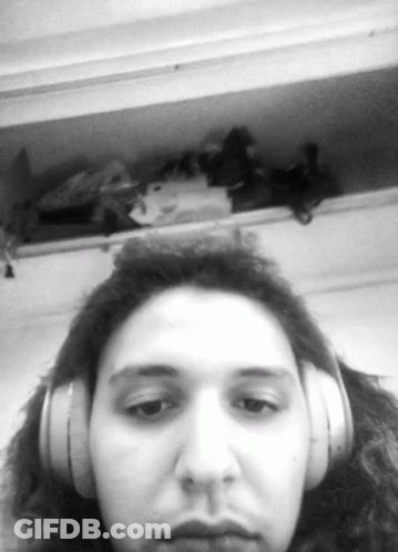 Woman With Headphones Looking At Camera GIF