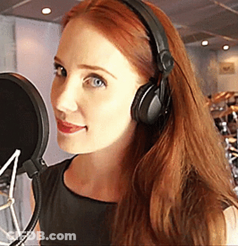 Woman With Headphones Smiling At Microphone GIF