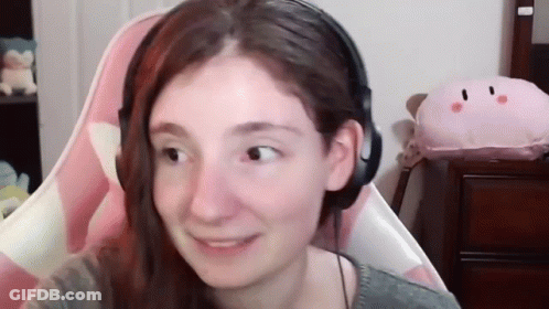Woman With Headphones Smiling In Pink Chair GIF
