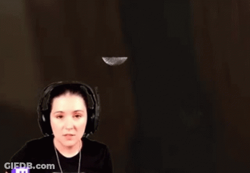 Woman With Headphones Standing In Front Of Wall With Flying Feather GIF