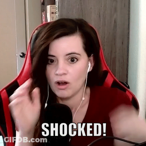 Woman With Headphones Surprised In Red Chair GIF