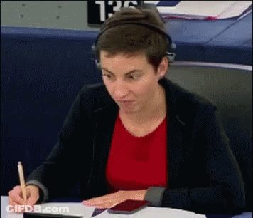 Woman With Headphones Writing At Desk GIF