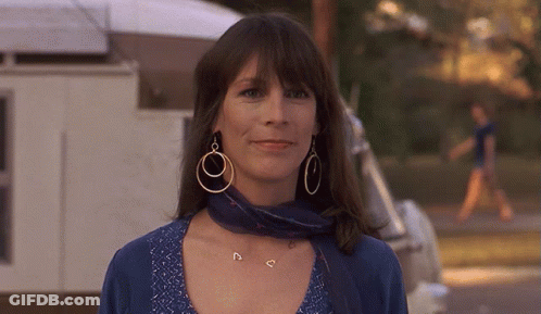 Woman With Hoop Earrings And Blue Scarf Smiles GIF