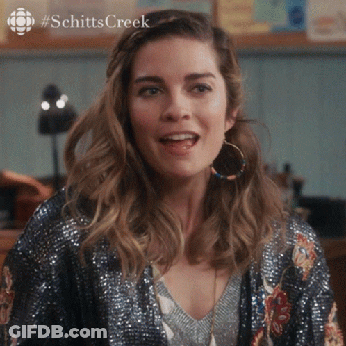 Woman With Hoop Earrings And Sequined Jacket Schitts Creek GIF