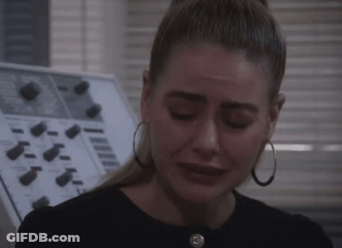 Woman With Hoop Earrings Crying In Front Of Control Panel GIF