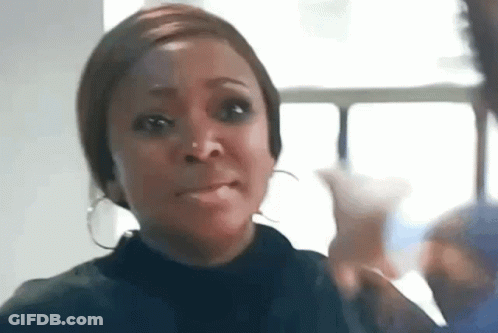 Woman With Hoop Earrings Making Funny Face By Window GIF