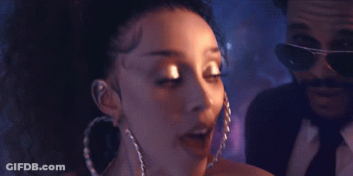 Woman With Hoop Earrings Next To Man In Suit GIF